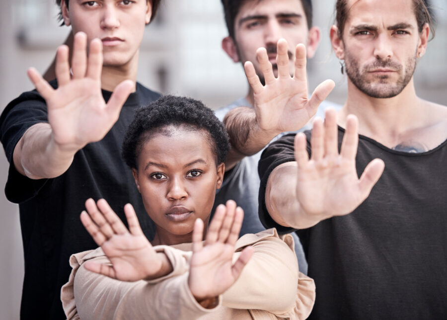 stop-gb-violence. Shot of a group of protestors raising their hands